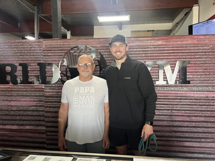 Landon with a client at World Gym